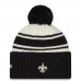 Шапка с помпоном New Orleans Saints New Era Cream/Black 2022 Sideline Sport Cuffed Knit